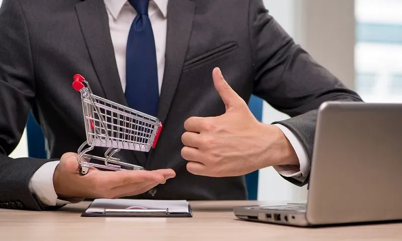 Businesswoman with shopping cart trolley