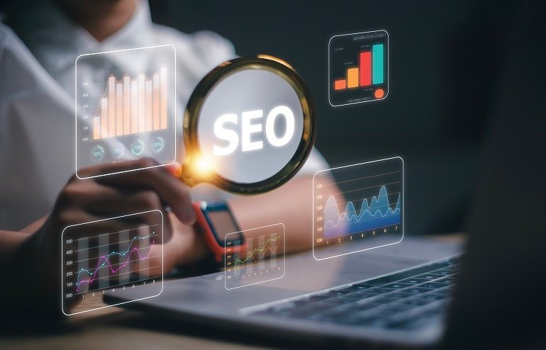 Women use magnifying glasses and computers for analysis of SEO,